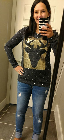 A polka-dot long sleeve top with sequins and a reindeer patch on front